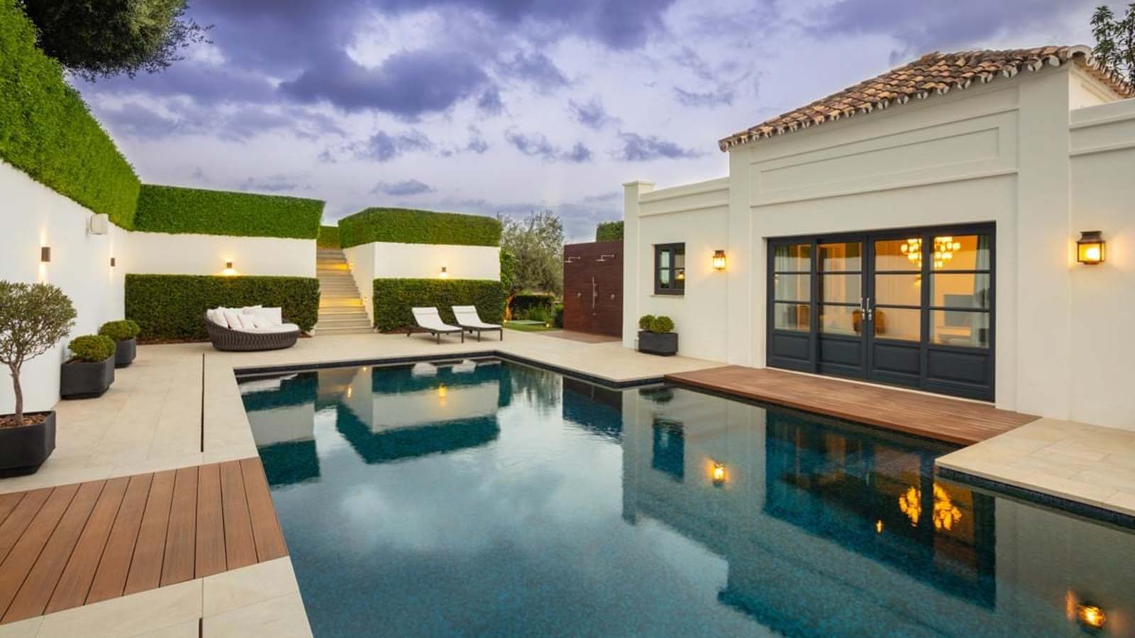 swimming pool next to luxury villa
