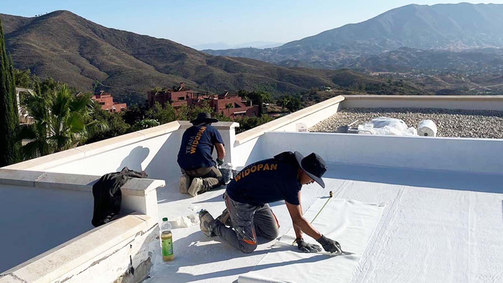 roofers fixing a flat roof in spain
